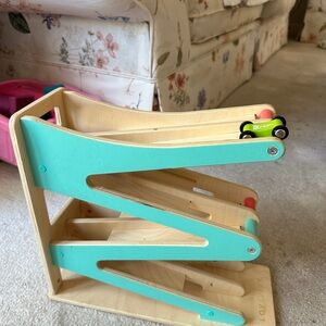 Lost the original car but has 3 amazon wooden cars instead .